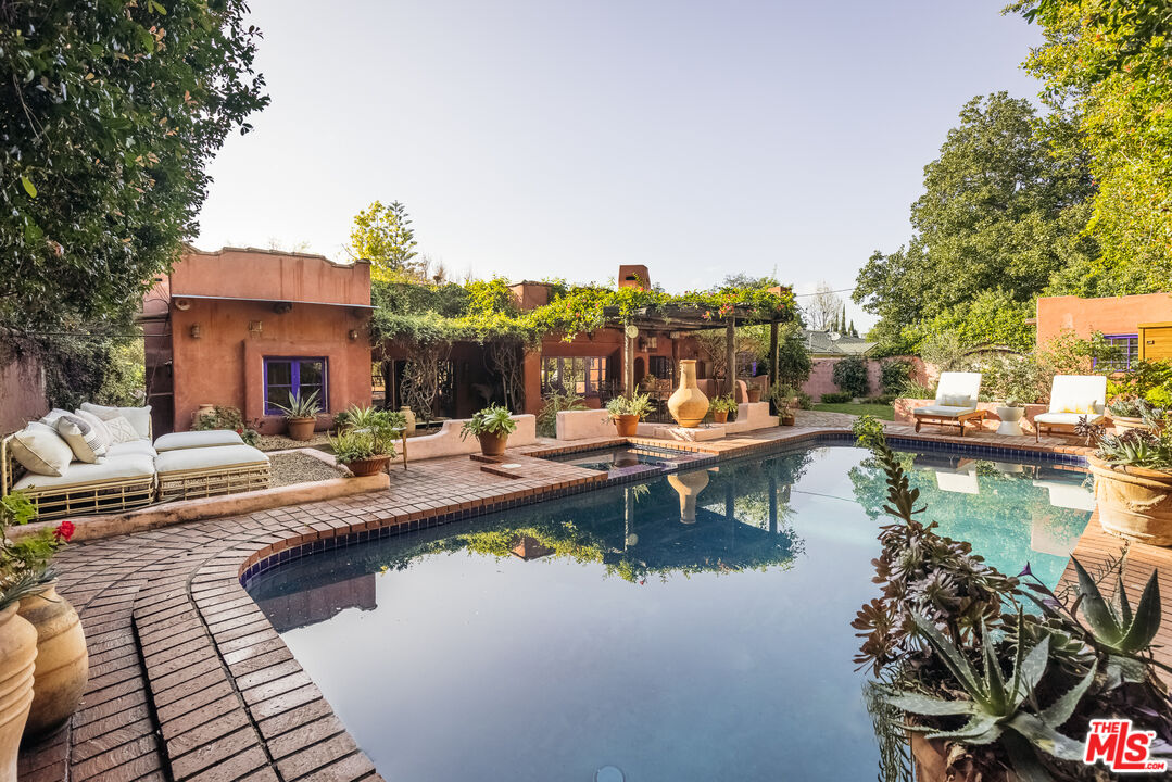 a view of a swimming pool with chairs