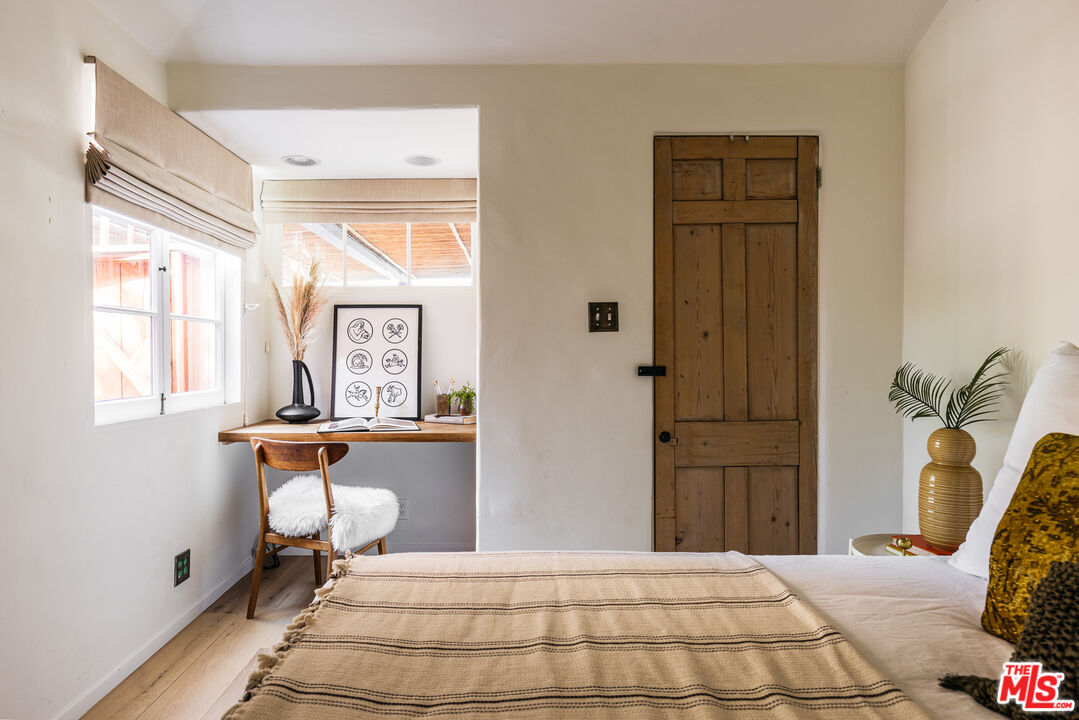 4342 Bakman Avenue Studio City, CA 91602 - Photo 18 of 31 a bedroom with a bed and wooden floor