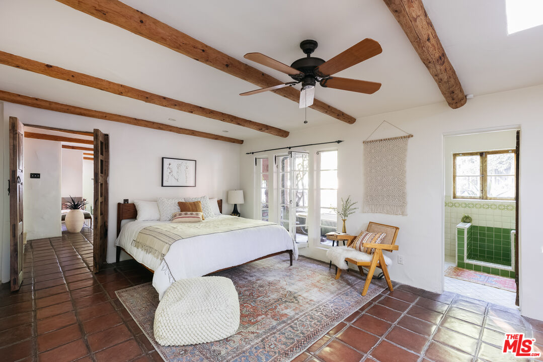 4342 Bakman Avenue Studio City, CA 91602 - Photo 19 of 31 a bed room with a bed and a chandelier