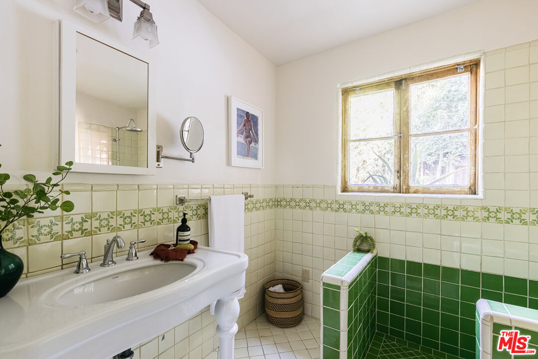 4342 Bakman Avenue Studio City, CA 91602 - Photo 20 of 31 a bathroom with a sink a toilet and a mirror