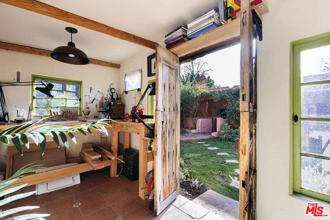 4342 Bakman Avenue Studio City, CA 91602 - Photo 27 of 31 a bedroom with a bed a large window and potted plant