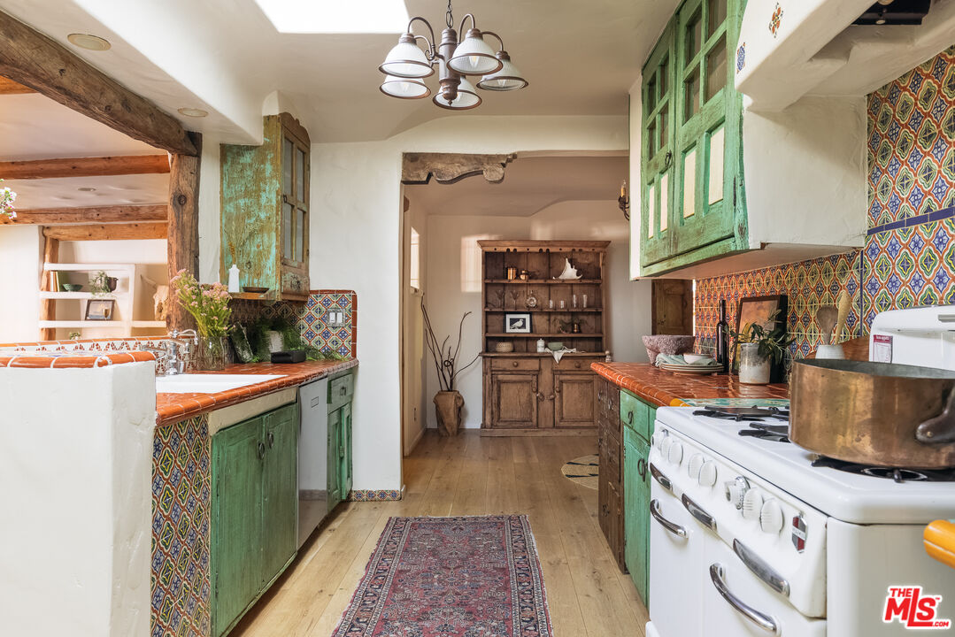 4342 Bakman Avenue Studio City, CA 91602 - Photo 9 of 31 a kitchen with stainless steel appliances granite countertop a stove a sink and a refrigerator