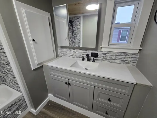 a bathroom with a sink and a mirror