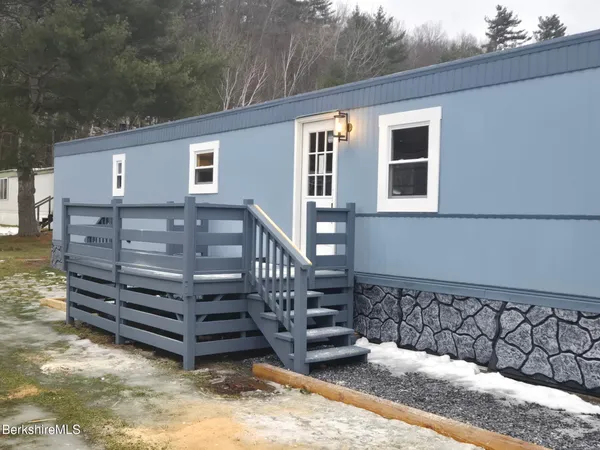 a view of a wooden house with a large tree