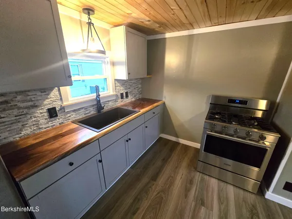 a kitchen with sink a window and stainless steel appliances