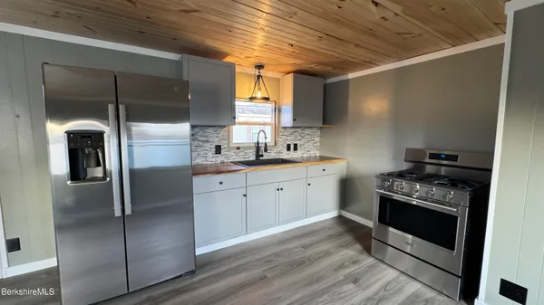 a kitchen with a refrigerator sink and stove