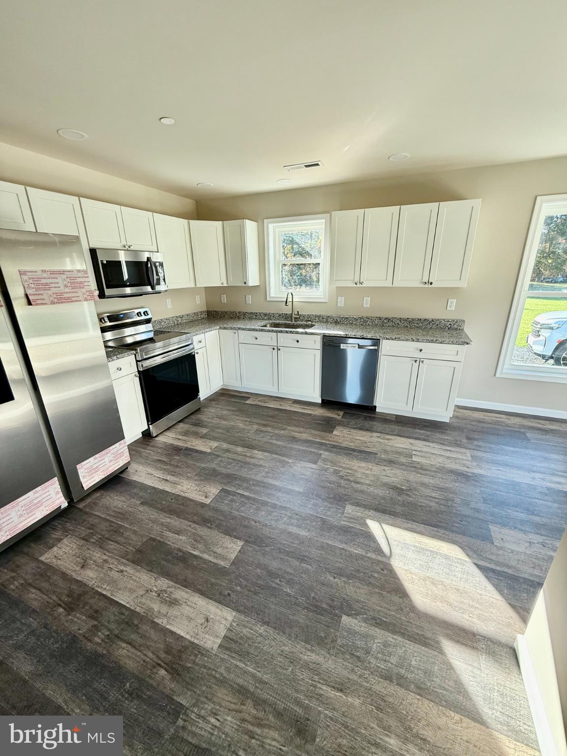 3963 Disharoon Road Eden, MD 21822 - Photo 18 of 61 a kitchen with granite countertop a stove and cabinets