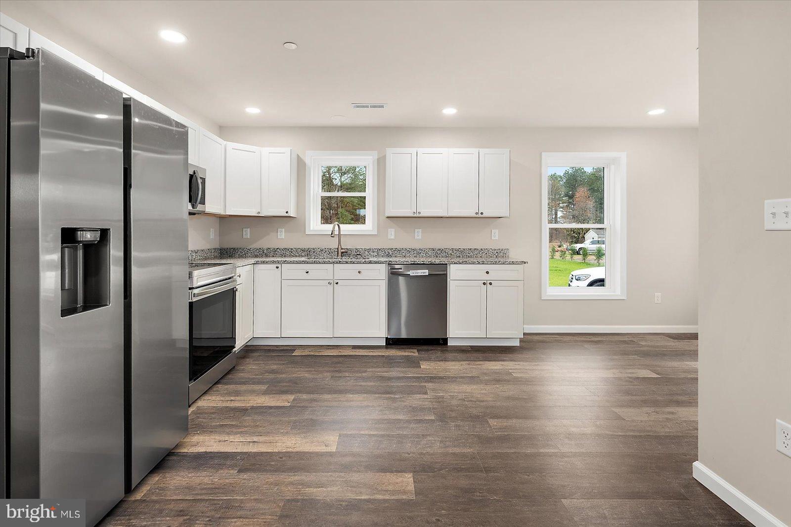 3963 Disharoon Road Eden, MD 21822 - Photo 20 of 61 a large kitchen with stainless steel appliances granite countertop a stove a sink and a refrigerator