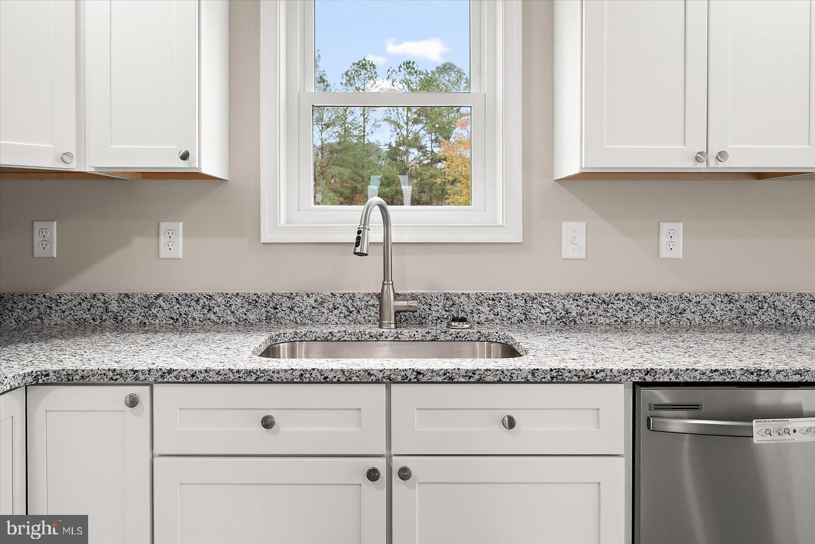 3963 Disharoon Road Eden, MD 21822 - Photo 21 of 61 a kitchen with granite countertop white cabinets and a window