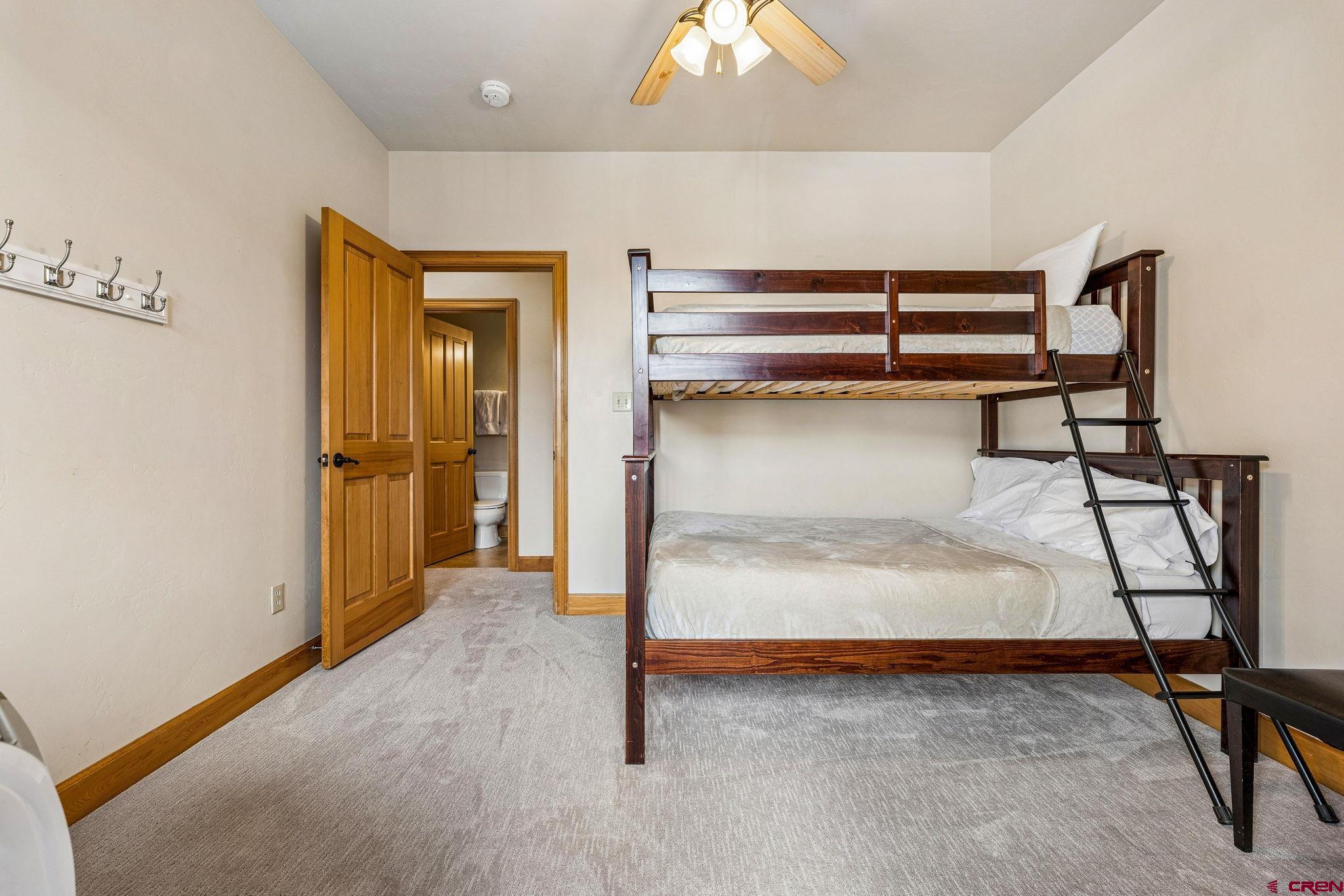 1422 Animas View Drive, Unit 55 Durango, CO 81301 - Photo 29 of 44 a bedroom with a bed and a table