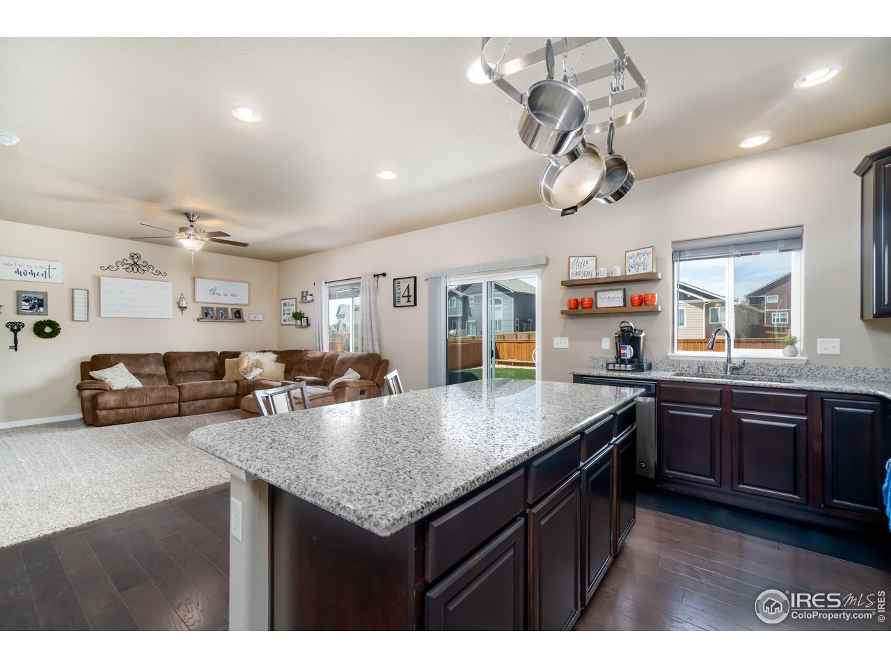 Kitchen open to Living Room and window overlooking backyard