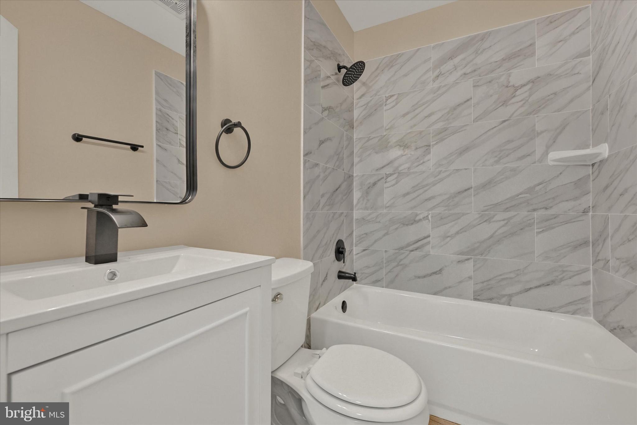 8577 Main Avenue Pasadena, MD 21122 - Photo 11 of 19 a bathroom with a granite countertop sink a toilet and bathtub