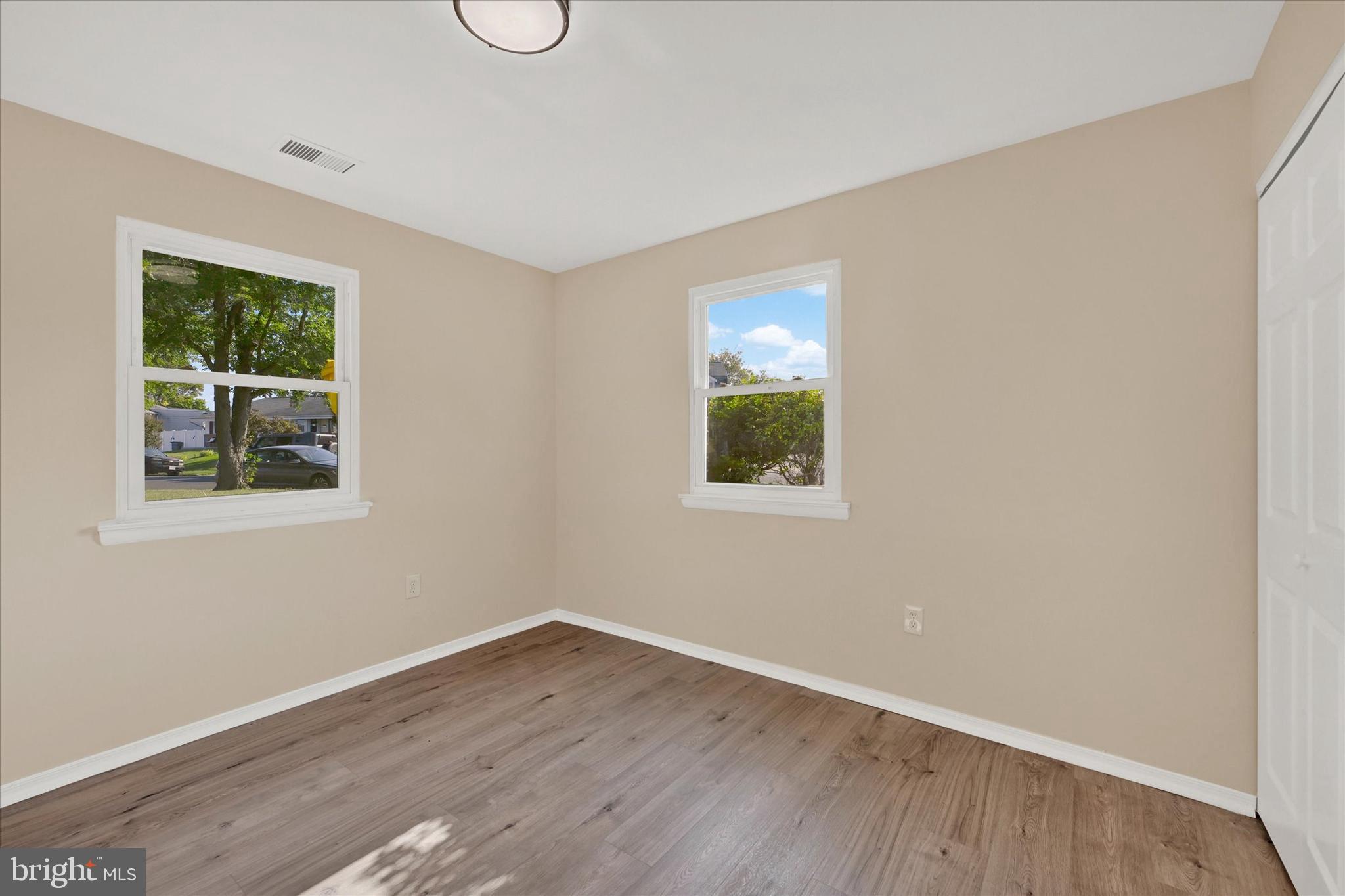 8577 Main Avenue Pasadena, MD 21122 - Photo 12 of 19 a view of an empty room with wooden floor and a window