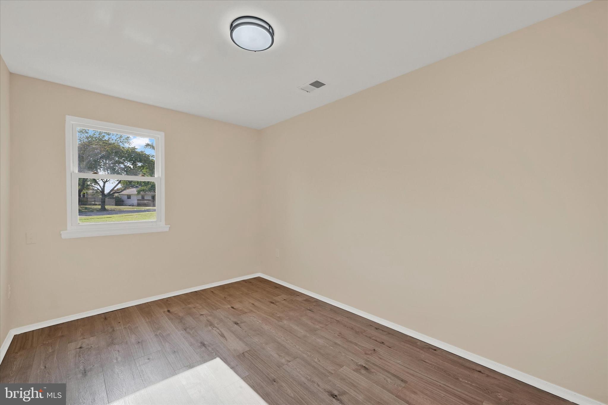 8577 Main Avenue Pasadena, MD 21122 - Photo 13 of 19 a view of a room with wooden floor and window