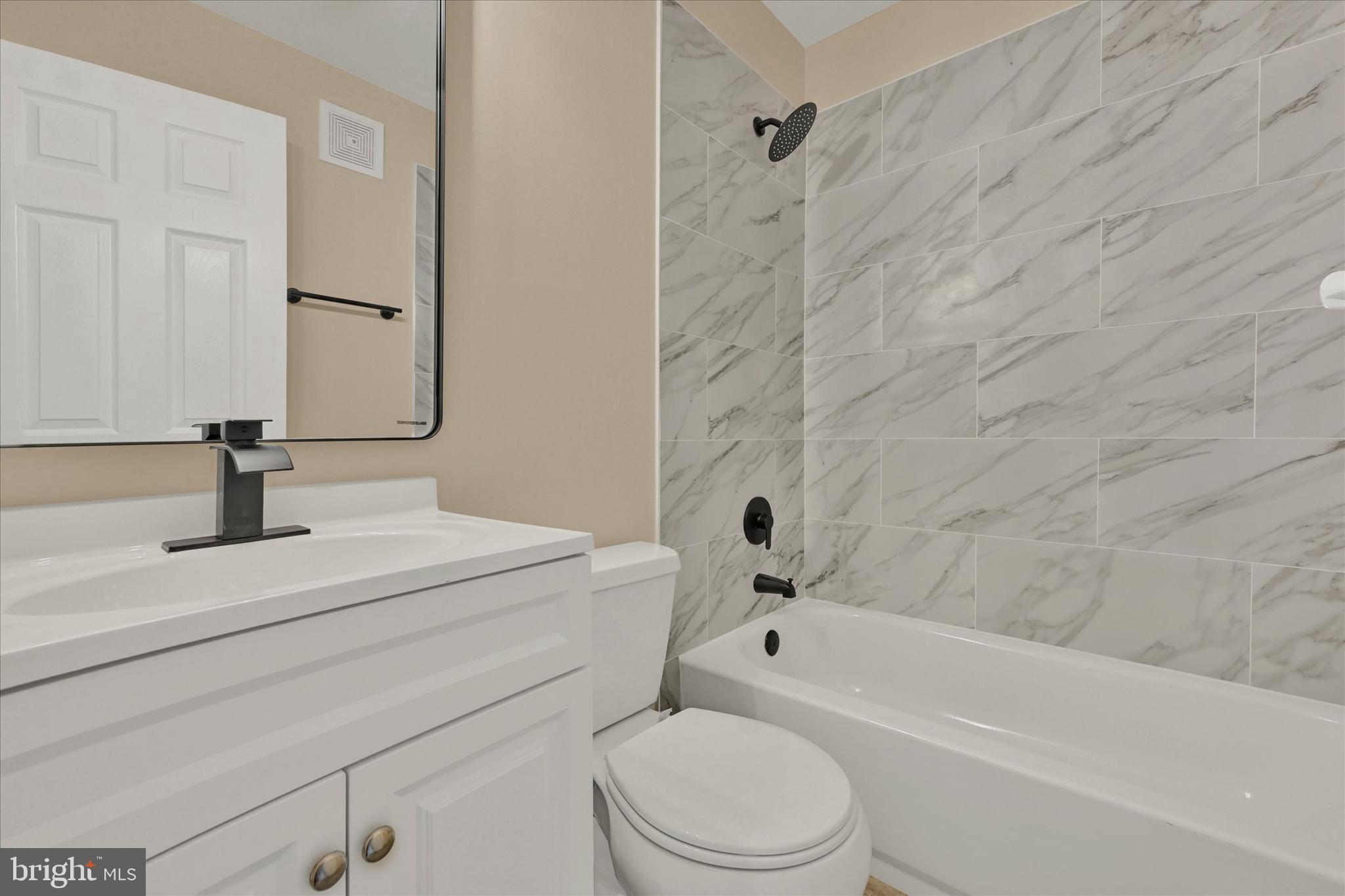 8577 Main Avenue Pasadena, MD 21122 - Photo 14 of 19 a bathroom with a sink a toilet and a bathtub