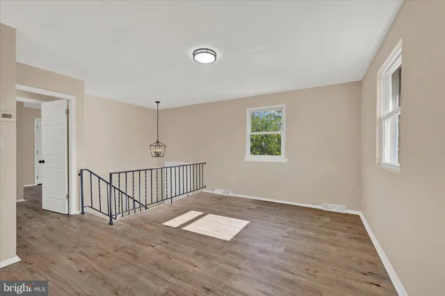 a view of a livingroom with wooden floor and window