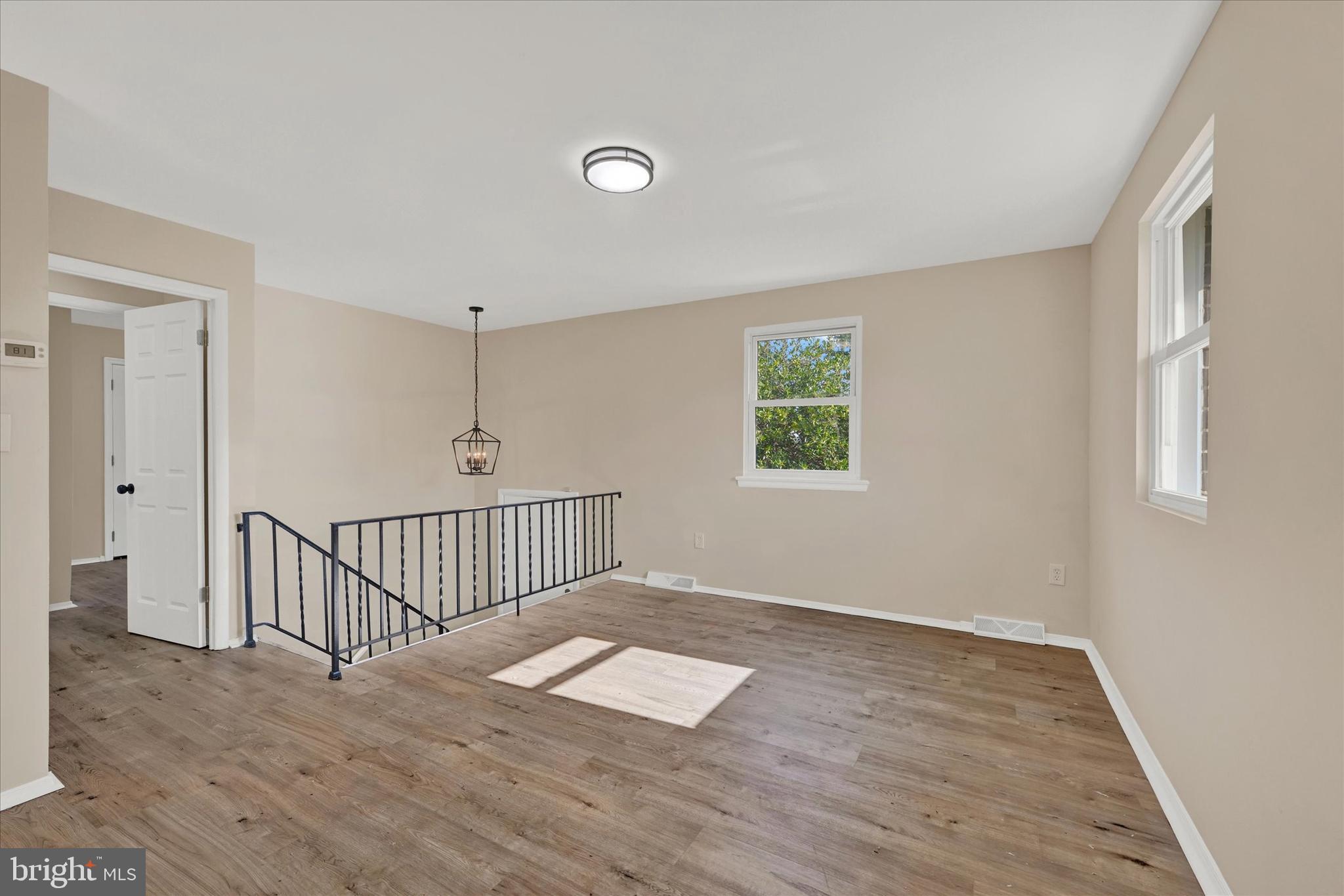 8577 Main Avenue Pasadena, MD 21122 - Photo 4 of 19 a view of a livingroom with wooden floor and window