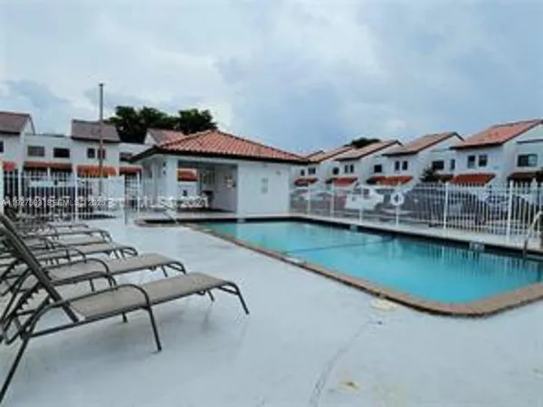an aerial view of a house with swimming pool garden view and a fire pit