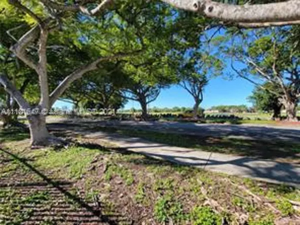 a view of a yard with wooden fence