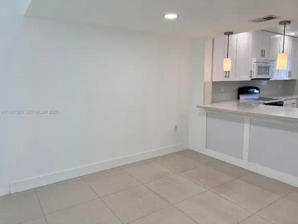 a view of cabinets and wooden floor