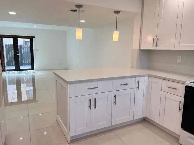 a kitchen with stainless steel appliances a sink and cabinets