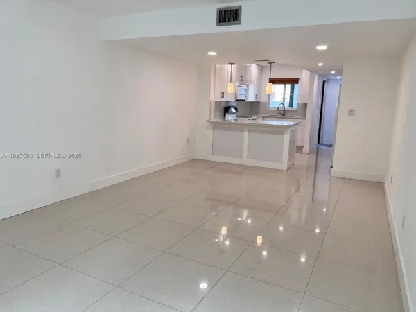 a kitchen with stainless steel appliances a sink and cabinets