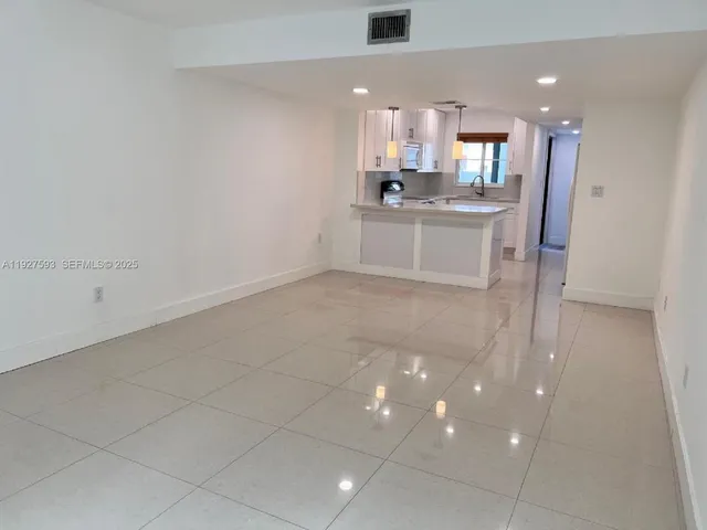 a view of a hallway with wooden floor and closet