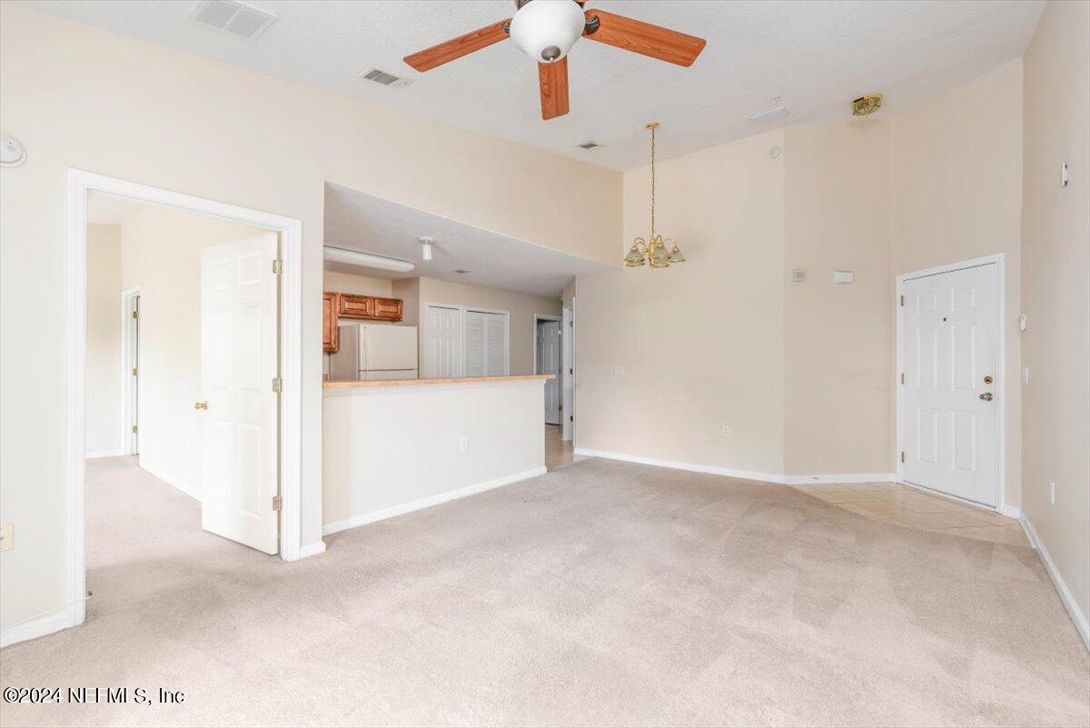 7920 Merrill Road, Unit 2013 Jacksonville, FL 32277 - Photo 7 of 21 a view of a livingroom with wooden floor and a ceiling fan