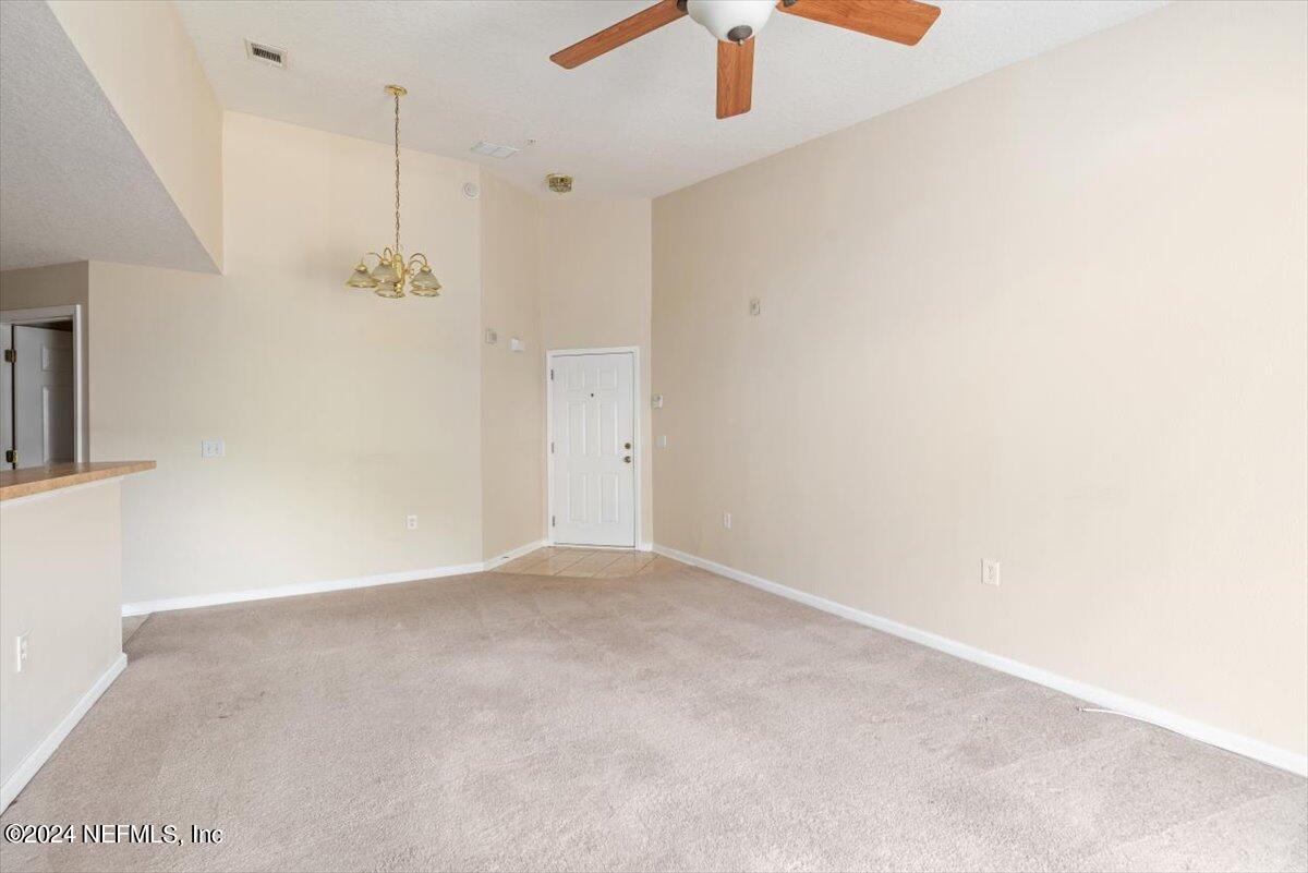 7920 Merrill Road, Unit 2013 Jacksonville, FL 32277 - Photo 8 of 21 an empty room with a ceiling fan and a window