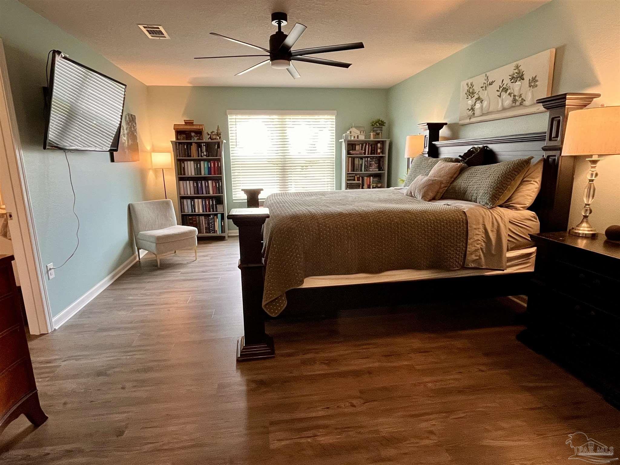5375 Peach Drive Milton, FL 32571 - Photo 17 of 34 a spacious bedroom with a bed and a flat screen tv
