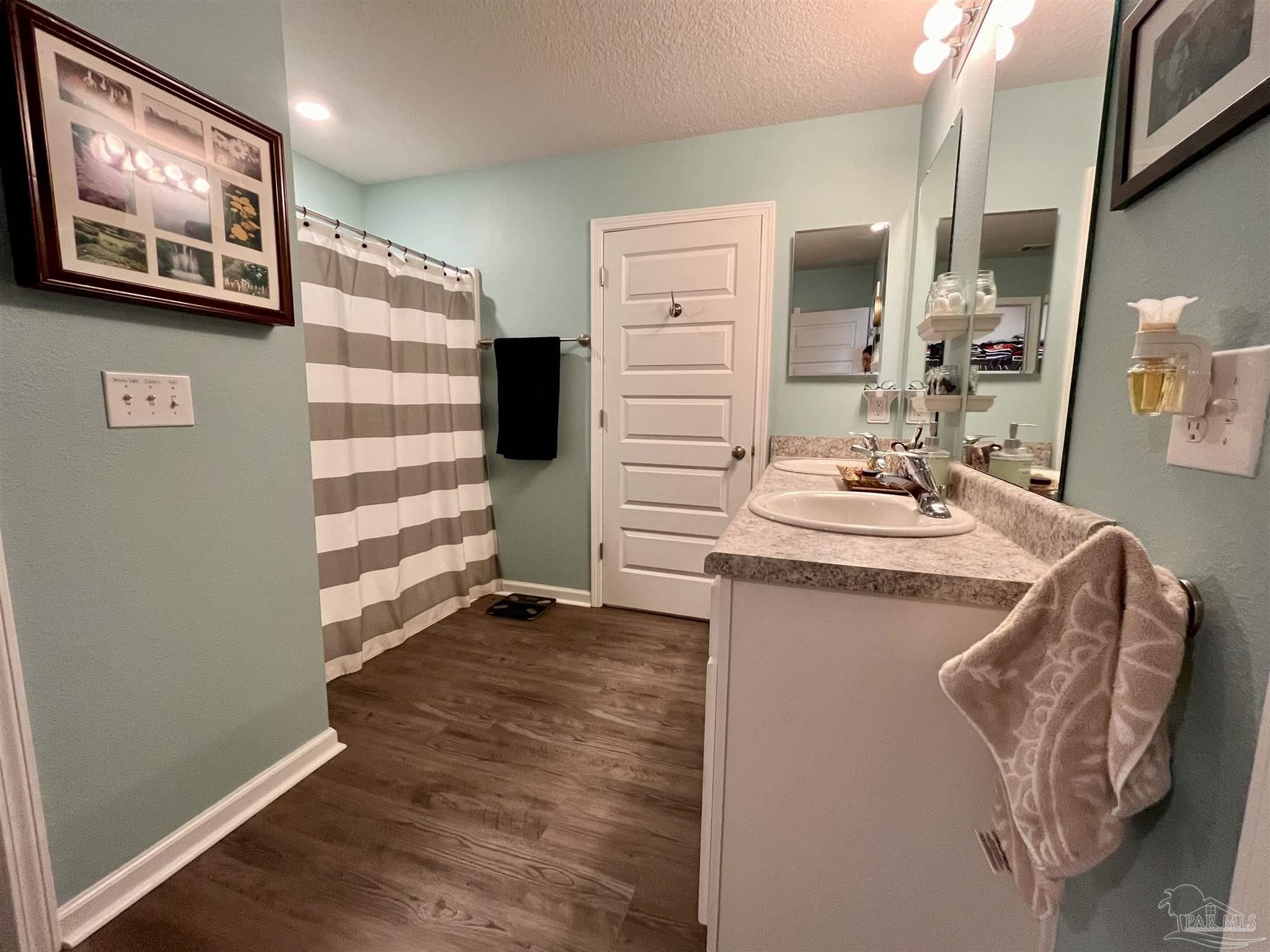 5375 Peach Drive Milton, FL 32571 - Photo 18 of 34 a kitchen with stainless steel appliances granite countertop a refrigerator and a stove top oven