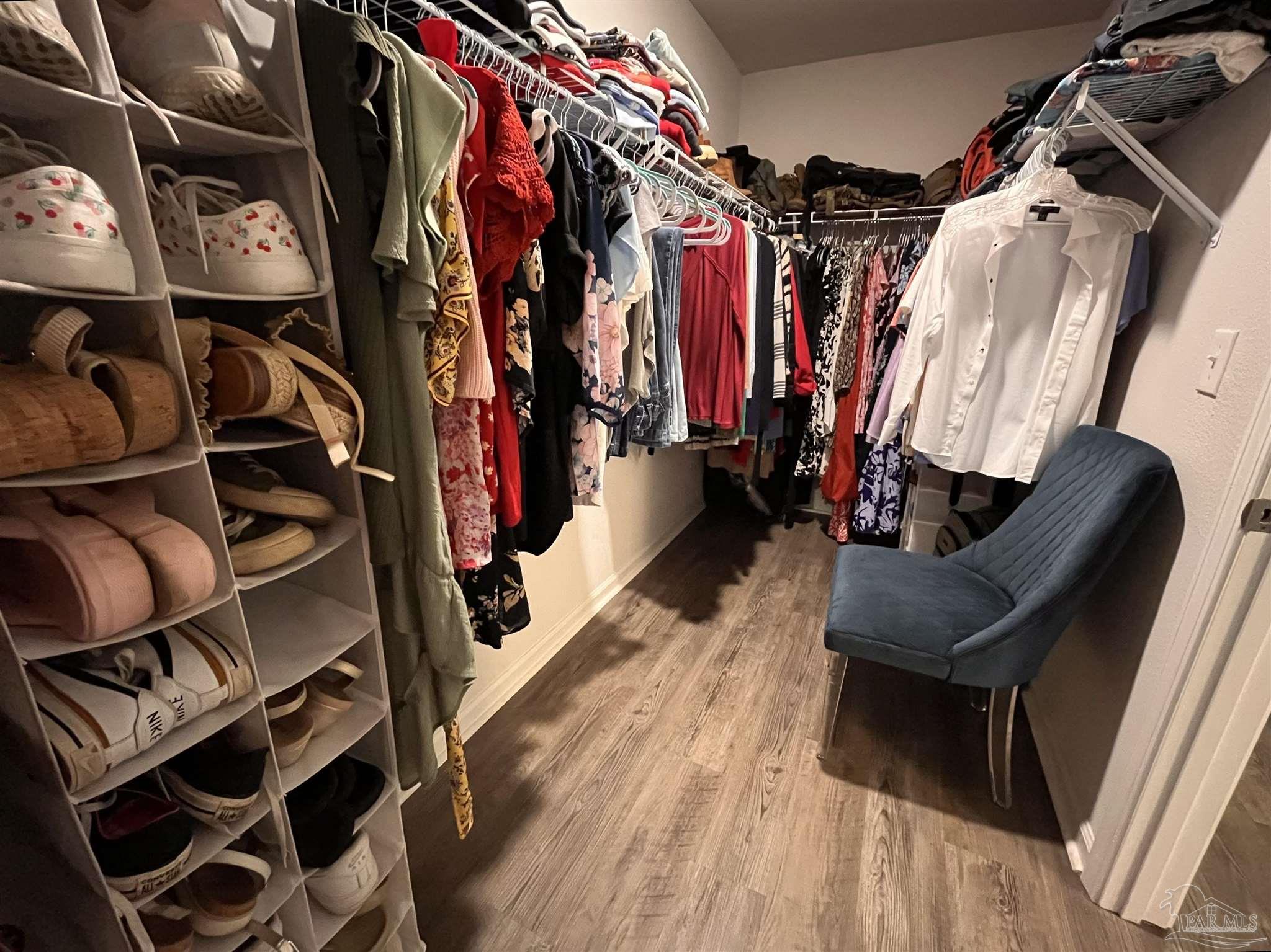 5375 Peach Drive Milton, FL 32571 - Photo 21 of 34 a view of walk in closet with clothes and shoes