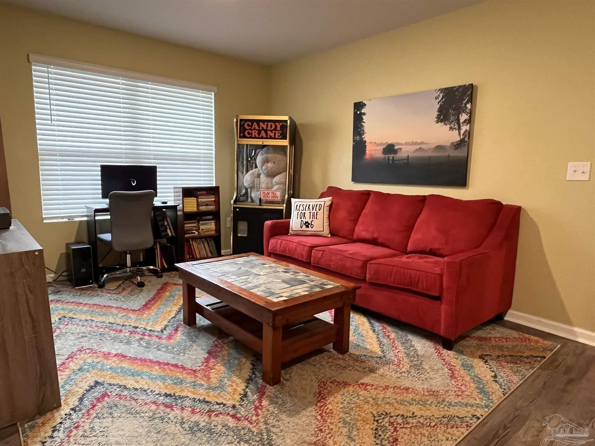 5375 Peach Drive Milton, FL 32571 - Photo 22 of 34 a living room with furniture and a flat screen tv