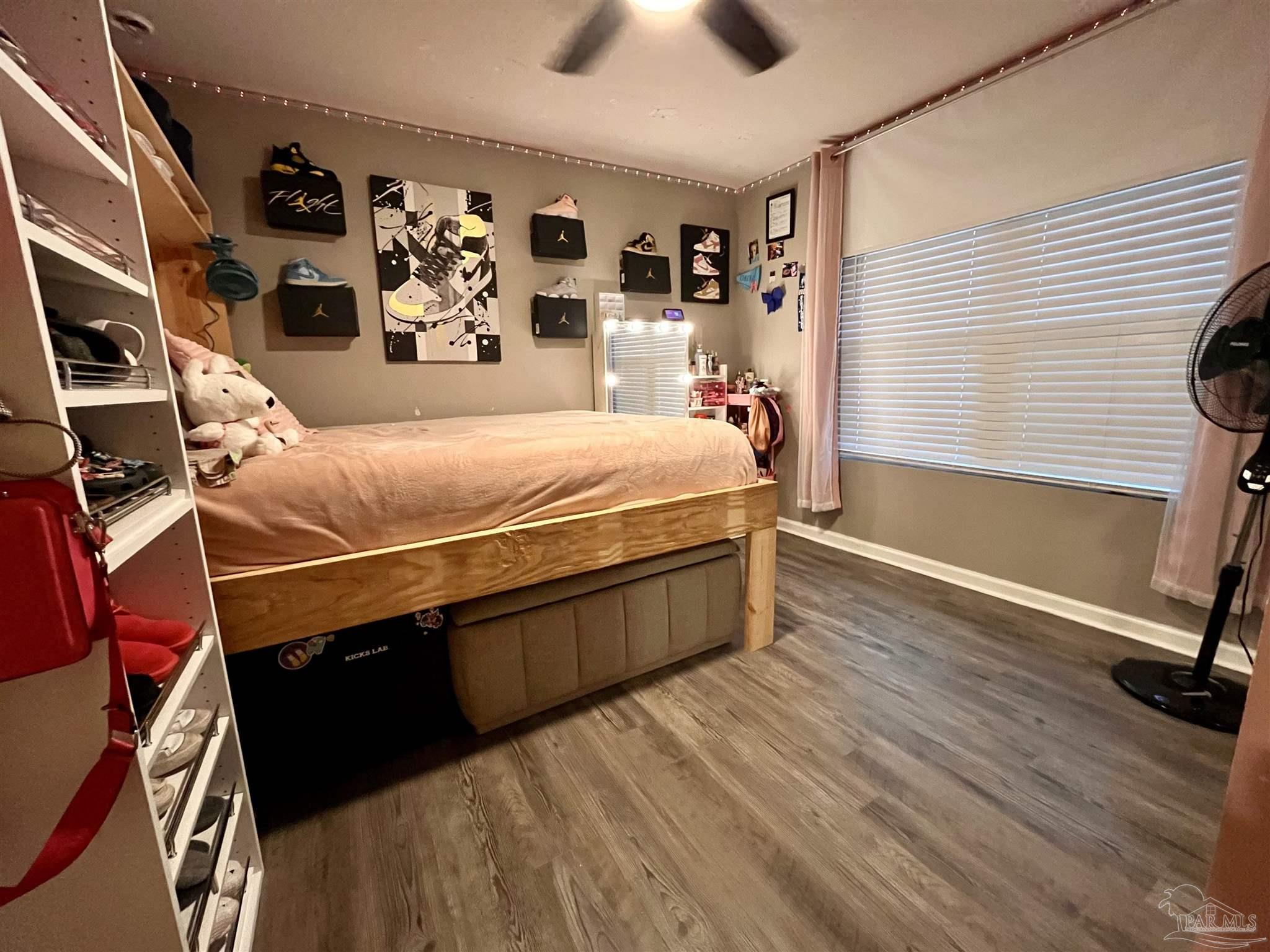 5375 Peach Drive Milton, FL 32571 - Photo 25 of 34 a bed room with a bed and a chandelier