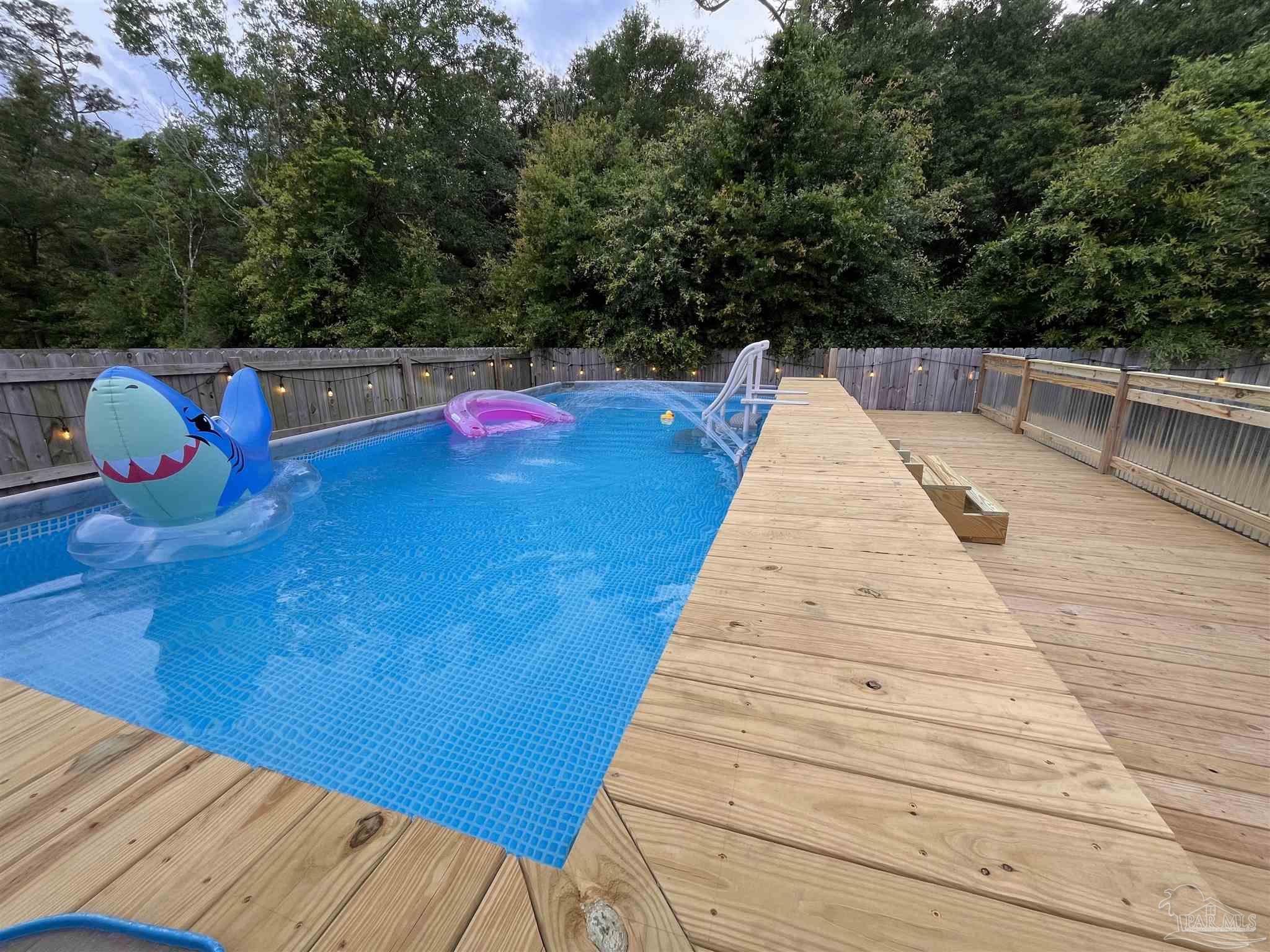 5375 Peach Drive Milton, FL 32571 - Photo 30 of 34 a view of swimming pool with sitting area