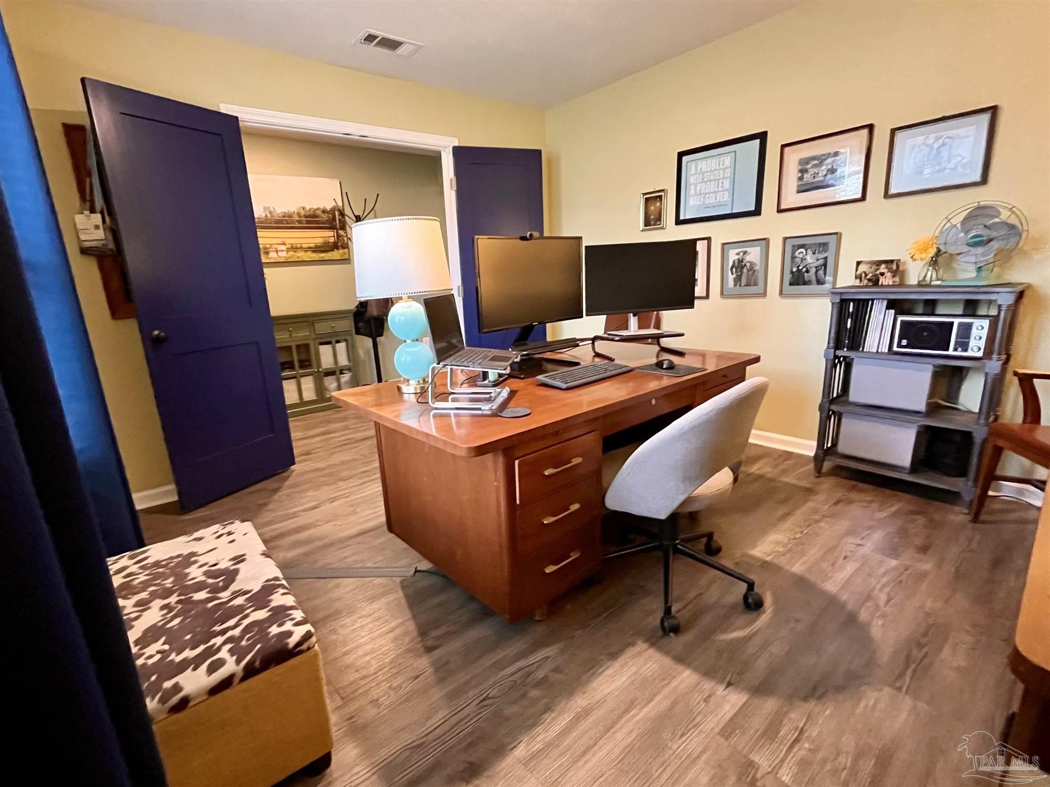 5375 Peach Drive Milton, FL 32571 - Photo 5 of 34 a room with furniture and a wooden floor