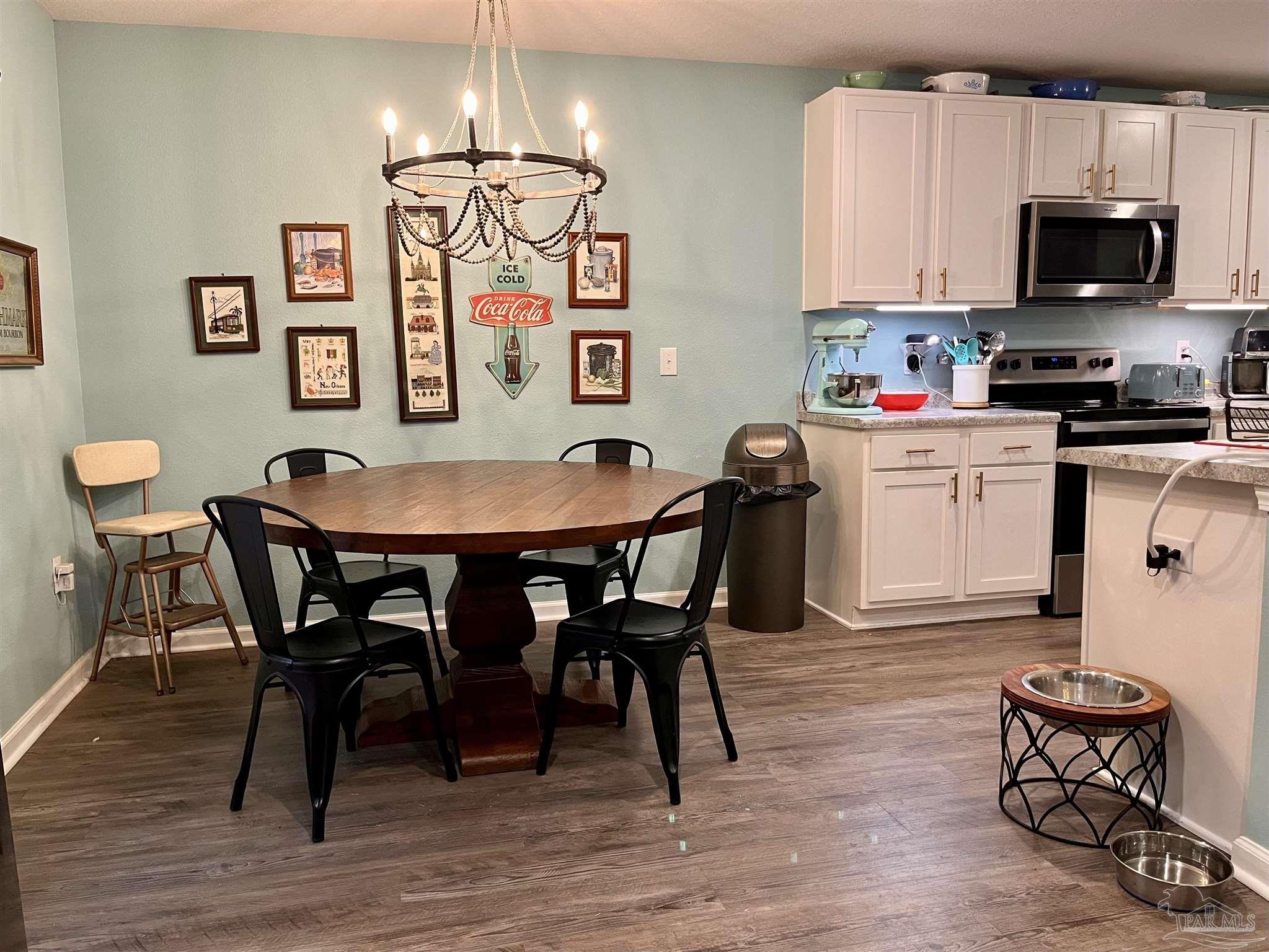 5375 Peach Drive Milton, FL 32571 - Photo 9 of 34 a kitchen with granite countertop a dining table chairs and a stove