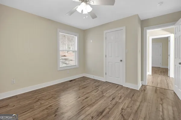 a spacious bedroom with a bed and a chandelier