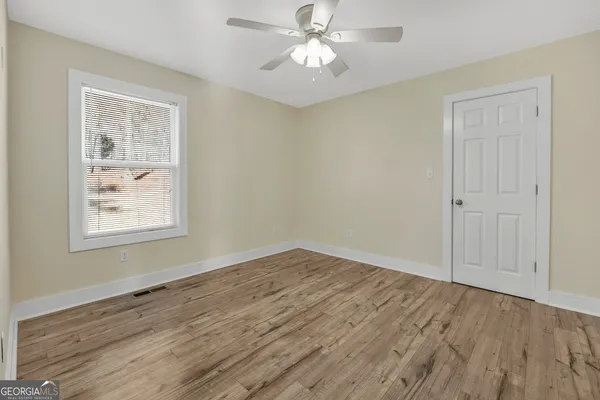 a spacious bedroom with a bed and a window