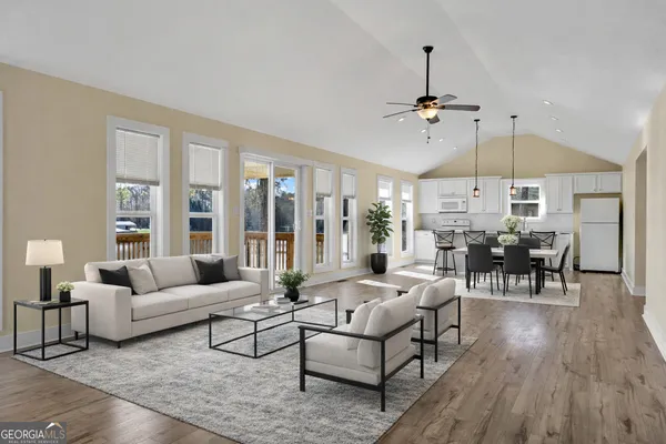 a living room with furniture a ceiling fan and a window