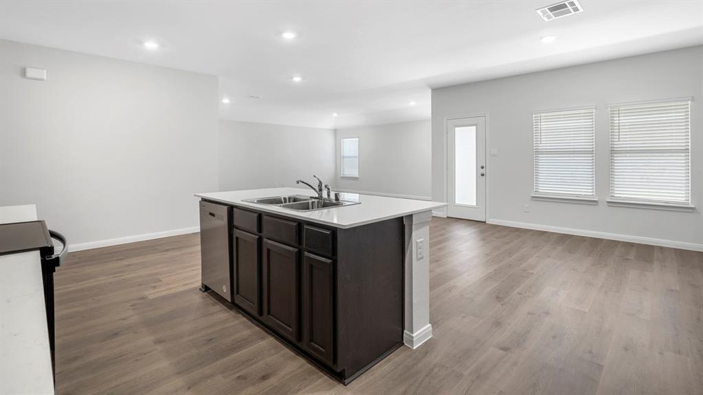 1921 Reveille Way Terrell, TX 75160 - Photo 28 of 30 a kitchen with a sink cabinets and wooden floor