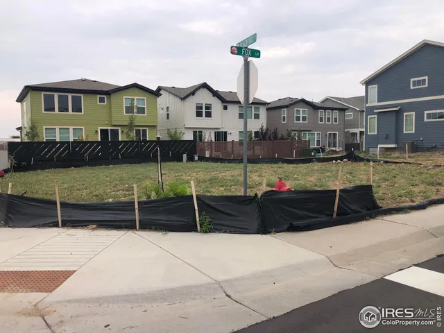 a view of a street with houses on the side of it