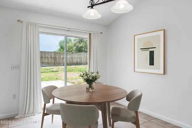 a view of a dining room with furniture and a potted plant