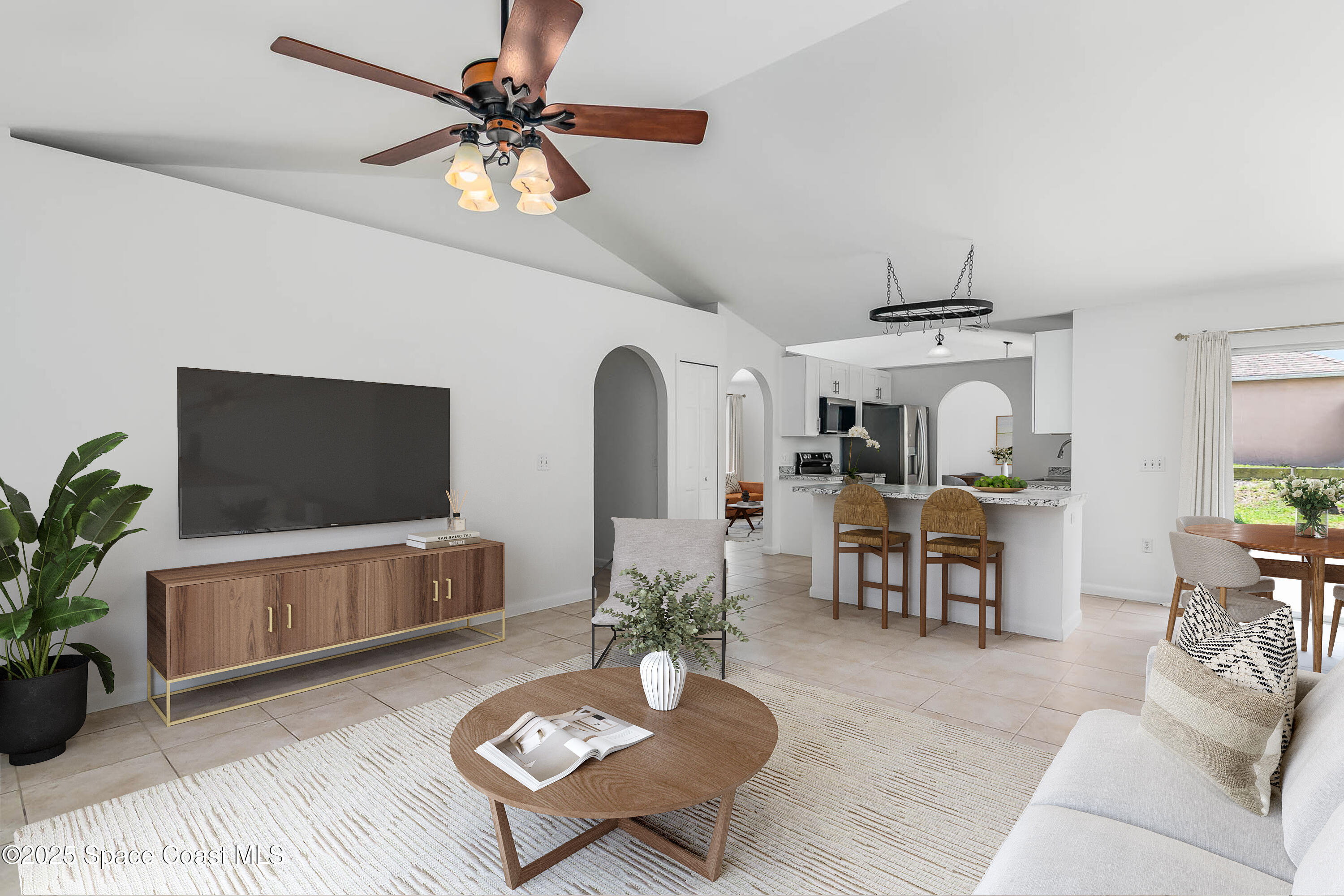 6760 Cairo Road Cocoa, FL 32927 - Photo 13 of 51 a living room with furniture a flat screen tv and a potted plant