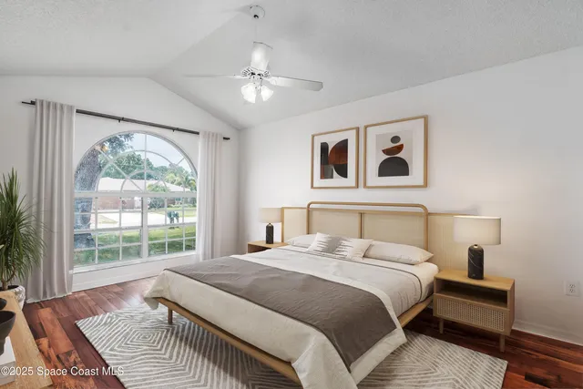 a bedroom with a large bed and a window