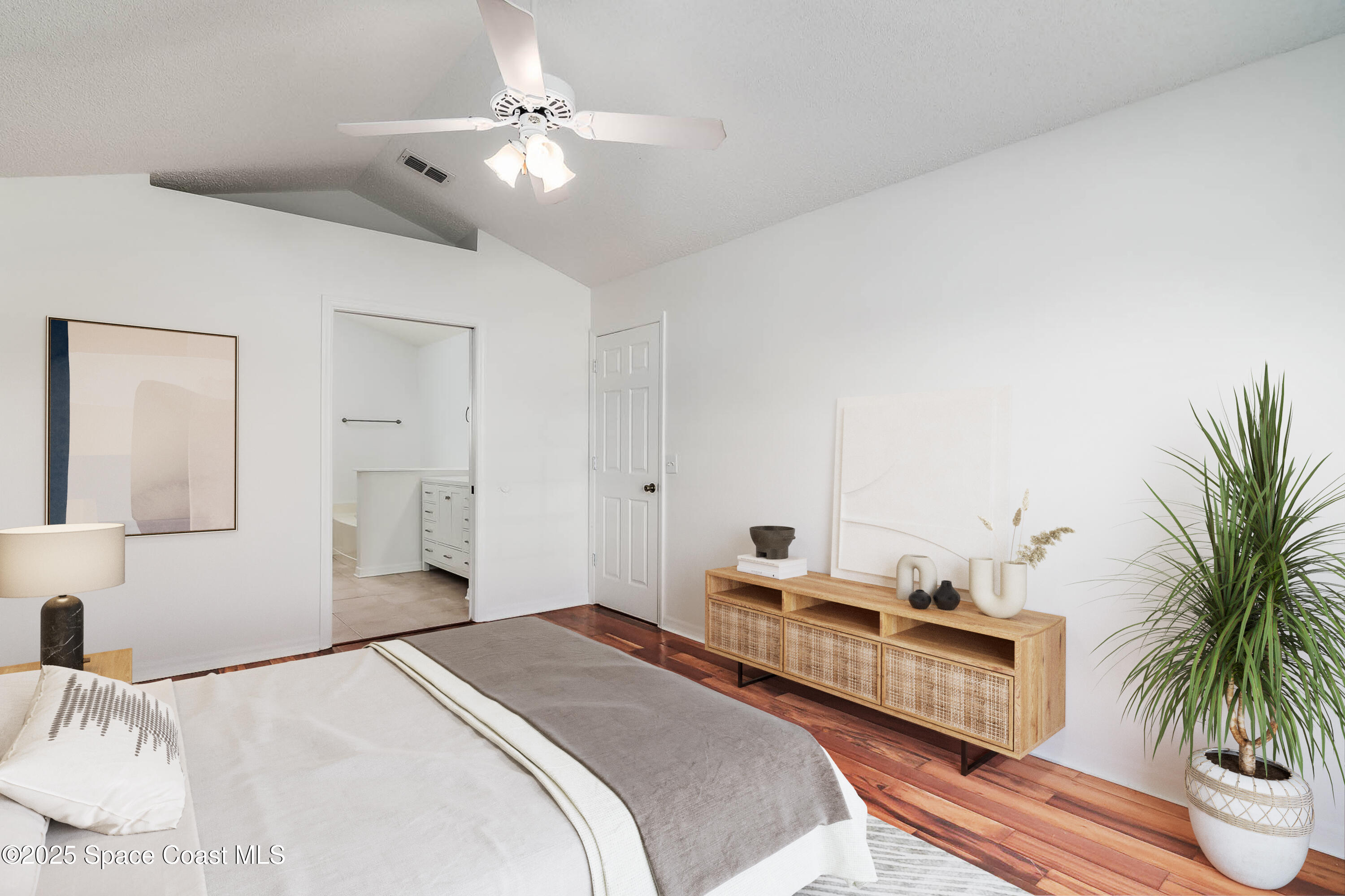 6760 Cairo Road Cocoa, FL 32927 - Photo 15 of 51 a bedroom with a bed and a potted plant