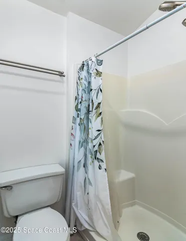 a bathroom with a toilet and shower