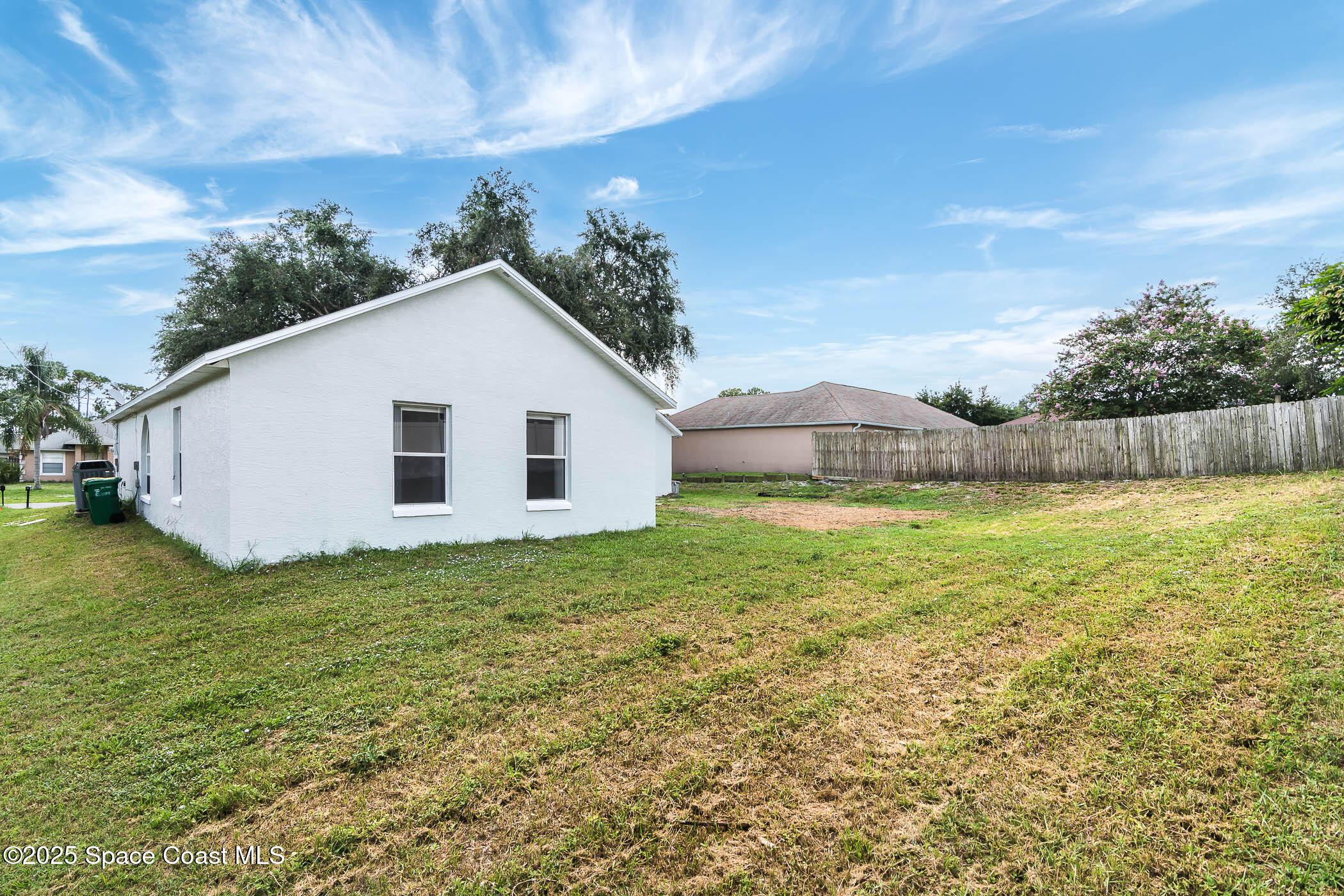 6760 Cairo Road Cocoa, FL 32927 - Photo 24 of 51 a view of a backyard with plants and a garden