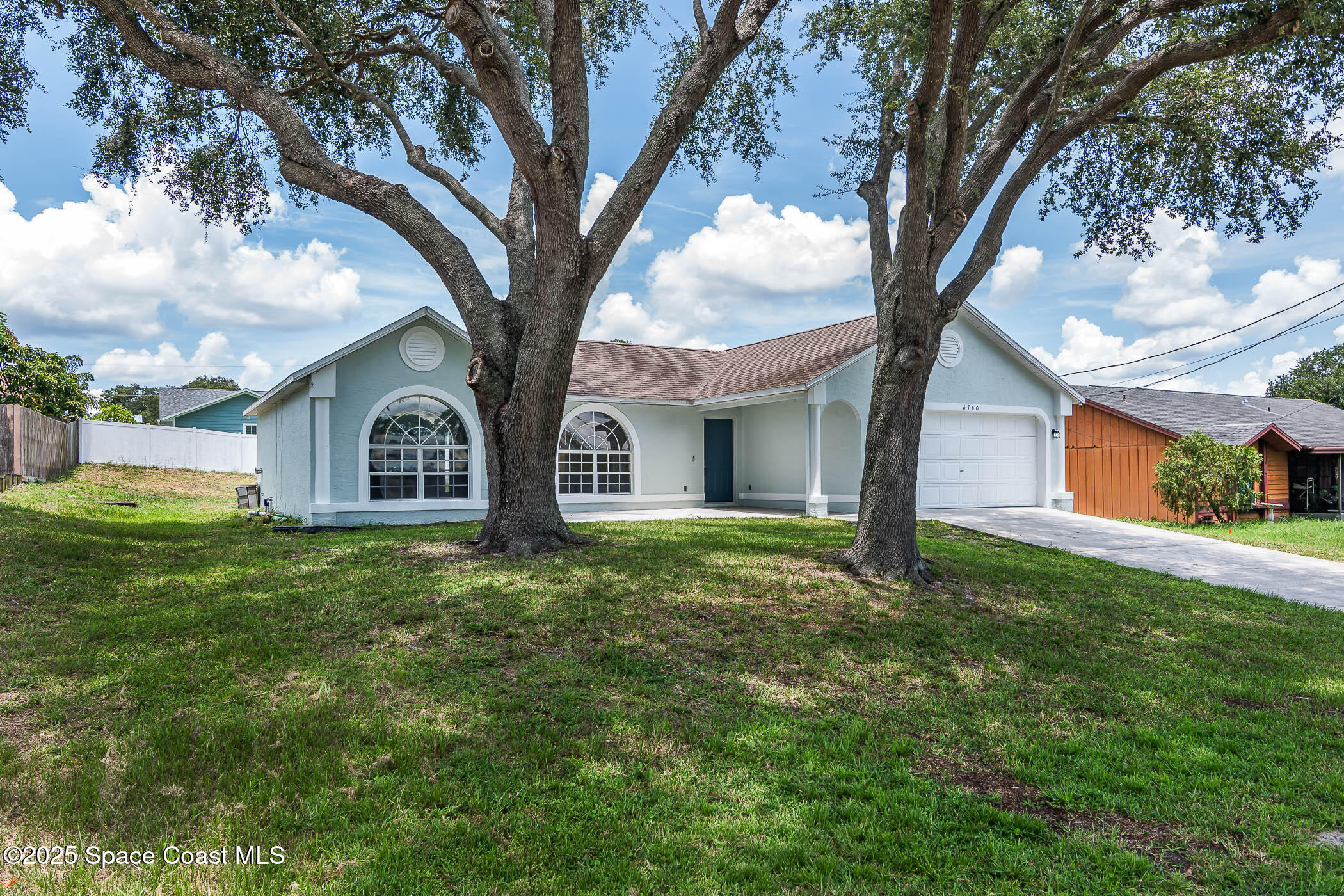 6760 Cairo Road Cocoa, FL 32927 - Photo 26 of 51 a view of a house with yard and tree s