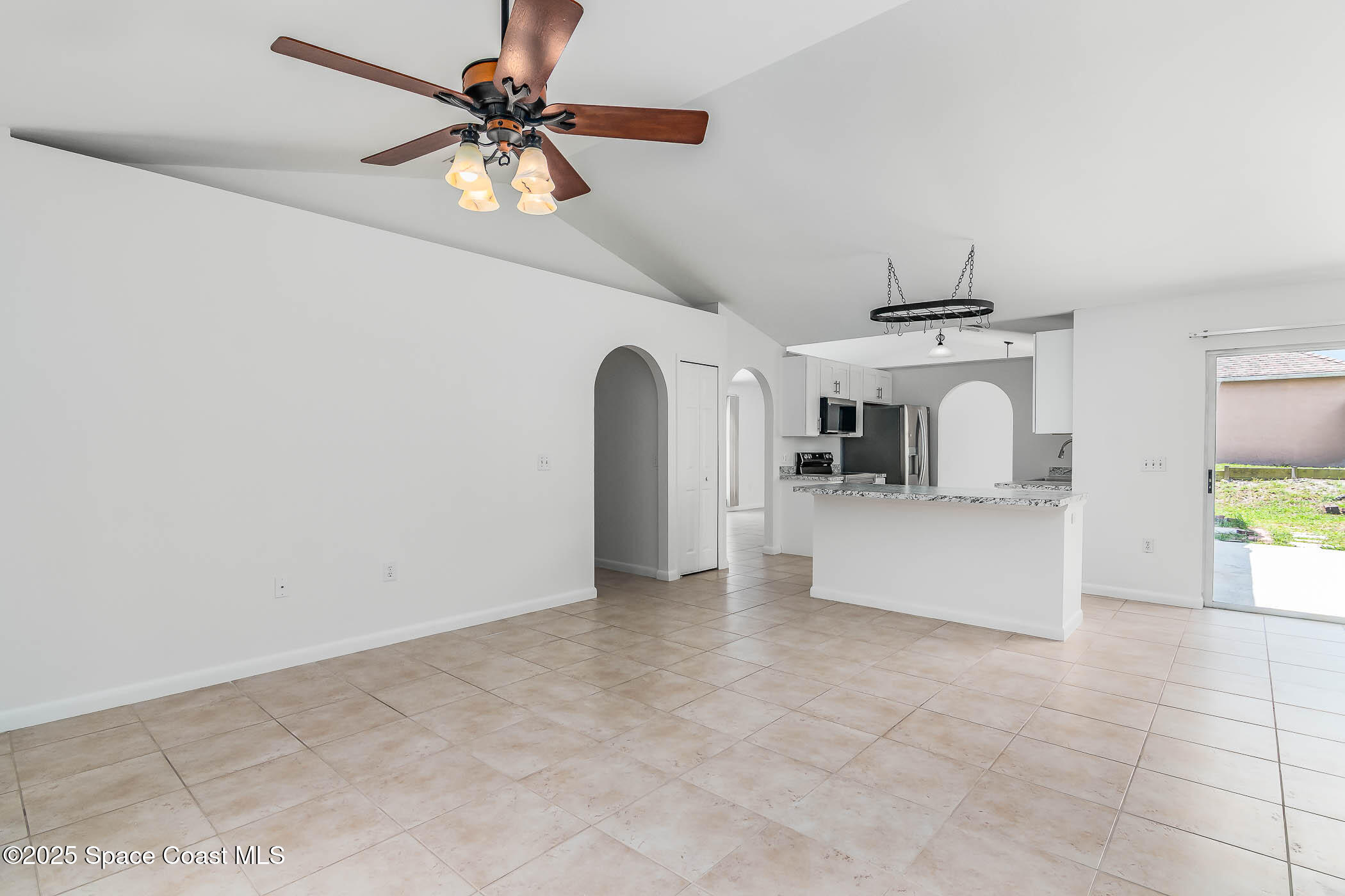 6760 Cairo Road Cocoa, FL 32927 - Photo 36 of 51 a view of a livingroom with a chair and a chandelier fan